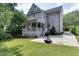 Exterior of house featuring gray siding, back porch, basketball hoop, and well-manicured yard at 1830 Wilshire Ave, Raleigh, NC 27608