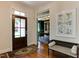 Inviting foyer featuring a hardwood floor, bench seating, and elegant entryway leading to office at 1830 Wilshire Ave, Raleigh, NC 27608