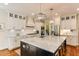 Spacious kitchen featuring a large island, stainless steel appliances, and elegant lighting fixtures at 1830 Wilshire Ave, Raleigh, NC 27608