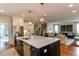 Kitchen with large center island that opens to the living room and staircase at 1830 Wilshire Ave, Raleigh, NC 27608