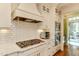 Modern kitchen featuring white cabinetry, stainless steel appliances, and marble countertops at 1830 Wilshire Ave, Raleigh, NC 27608