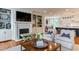 Comfortable living room featuring a fireplace, built-in shelving, and open-concept kitchen view at 1830 Wilshire Ave, Raleigh, NC 27608