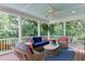 Screened-in porch with comfortable seating, ceiling fan, and view of backyard at 1830 Wilshire Ave, Raleigh, NC 27608
