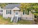 Charming single-story home featuring beige siding, green shutters, and a cozy front porch at 203 Spring Street St, Louisburg, NC 27549