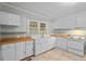 The kitchen features white cabinetry, butcher block countertops, and tile flooring at 203 Spring Street St, Louisburg, NC 27549