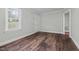 Bright room featuring hardwood floors, freshly painted walls, and a large window that provides natural light at 203 Spring Street St, Louisburg, NC 27549