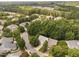 A beautiful aerial view of a neighborhood featuring tree-lined streets, lush greenery, and well-maintained homes at 208 Rockport Ridge Way, Cary, NC 27519