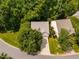 Aerial view of a well maintained house with a driveway, lush green lawn, and mature trees in a quiet neighborhood at 208 Rockport Ridge Way, Cary, NC 27519