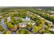 Aerial view of community amenities including a pond with a fountain, tennis courts, and clubhouse with seating area at 208 Rockport Ridge Way, Cary, NC 27519