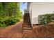 Image shows backyard with stairs leading to upper deck at 208 Rockport Ridge Way, Cary, NC 27519