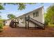 Backyard view of house with upper deck and stairs to yard at 208 Rockport Ridge Way, Cary, NC 27519