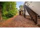 Backyard view showing wooden staircase leading to upper deck at 208 Rockport Ridge Way, Cary, NC 27519