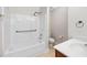 Bathroom with white tub/shower combo, toilet, and single sink at 208 Rockport Ridge Way, Cary, NC 27519