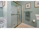 Shower and toilet in bathroom with tiled floor and blue walls at 208 Rockport Ridge Way, Cary, NC 27519