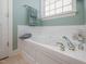 Bathroom featuring a large bathtub with decorative elements, plus chrome fixtures at 208 Rockport Ridge Way, Cary, NC 27519