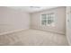 Bedroom featuring neutral carpet, a ceiling fan, and a window with blinds at 208 Rockport Ridge Way, Cary, NC 27519