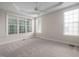 Bedroom with tray ceiling, carpet, and multiple windows offering plenty of natural light at 208 Rockport Ridge Way, Cary, NC 27519