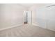 Bedroom featuring neutral carpet and a double door closet at 208 Rockport Ridge Way, Cary, NC 27519