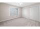 Bedroom featuring neutral carpet, a window with blinds, and a double door closet at 208 Rockport Ridge Way, Cary, NC 27519
