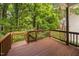 Wooden deck overlooking the backyard's lush greenery and trees at 208 Rockport Ridge Way, Cary, NC 27519