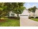 Beautiful home with a well-maintained lawn, mature tree, and a convenient two-car garage at 208 Rockport Ridge Way, Cary, NC 27519