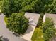 Aerial view of a home with an attached two-car garage, an inviting driveway, and mature trees in a friendly neighborhood at 208 Rockport Ridge Way, Cary, NC 27519