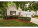 Charming home featuring manicured landscaping, a two-car garage, and a welcoming entrance at 208 Rockport Ridge Way, Cary, NC 27519