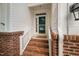 Cozy front entrance with brick steps, white railings, and a charming glass-paneled door at 208 Rockport Ridge Way, Cary, NC 27519