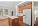 Bright kitchen with wooden cabinets, a refrigerator, and an island at 208 Rockport Ridge Way, Cary, NC 27519