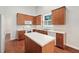 Spacious kitchen with wooden cabinets, an island, and modern appliances at 208 Rockport Ridge Way, Cary, NC 27519