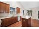 Well-lit kitchen featuring wooden cabinetry, an island, and modern appliances at 208 Rockport Ridge Way, Cary, NC 27519