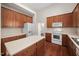 Fully equipped kitchen with wooden cabinets, an island, and appliances at 208 Rockport Ridge Way, Cary, NC 27519