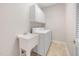 Functional laundry room with sink, washer, dryer, and storage cabinets, for convenient chores at 208 Rockport Ridge Way, Cary, NC 27519