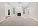 Spacious living room with a fireplace and access to the backyard at 208 Rockport Ridge Way, Cary, NC 27519