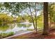 Scenic view of the pond with a fountain and lush trees at 208 Rockport Ridge Way, Cary, NC 27519