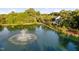 Scenic view of the pond with a fountain and lush greenery surrounding the property at 208 Rockport Ridge Way, Cary, NC 27519