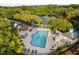 An aerial view of the community pool with lounge chairs, umbrellas, and landscaped surroundings at 208 Rockport Ridge Way, Cary, NC 27519