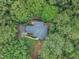 Aerial view of a beautiful home nestled amongst lush green trees, ensuring privacy at 2095 Woodberry Dr, Clayton, NC 27527