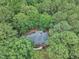 Aerial view of a home with a dark roof surrounded by large trees and lush landscaping at 2095 Woodberry Dr, Clayton, NC 27527