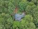 Aerial view of a house nestled among tall trees, showcasing privacy and seclusion at 2095 Woodberry Dr, Clayton, NC 27527