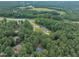 Aerial view showing properties surrounded by lush trees and other homes at 2095 Woodberry Dr, Clayton, NC 27527