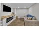 Cozy basement living room with a linear fireplace and mounted TV at 2095 Woodberry Dr, Clayton, NC 27527