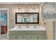 Bathroom features double sinks, framed mirror, and updated lighting fixtures at 2095 Woodberry Dr, Clayton, NC 27527
