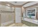 Bathroom features include a tub, glass shower and a window bringing in natural light at 2095 Woodberry Dr, Clayton, NC 27527