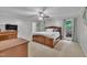 Spacious bedroom with warm carpet, windows with green views and wood furnishings at 2095 Woodberry Dr, Clayton, NC 27527