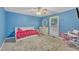 Cheerful bedroom with bright blue walls, carpet flooring, and window at 2095 Woodberry Dr, Clayton, NC 27527