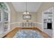 Bright dining room with decorative rug, modern chandelier and an adjacent room at 2095 Woodberry Dr, Clayton, NC 27527