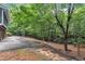 Private driveway leading to a home surrounded by lush greenery and mature trees at 2095 Woodberry Dr, Clayton, NC 27527