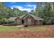 Traditional brick home featuring arched windows, lush landscaping, and a well-manicured front yard at 2095 Woodberry Dr, Clayton, NC 27527