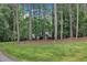 Brick home nestled among mature trees with a large front yard and well manicured lawn at 2095 Woodberry Dr, Clayton, NC 27527